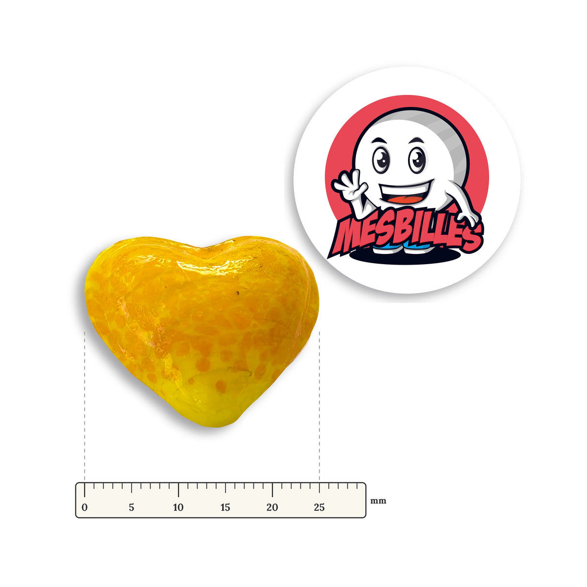 Bille Coeur Jaune Mouchetée Orange à côté d'une règle graduée, environ 25 mm de large