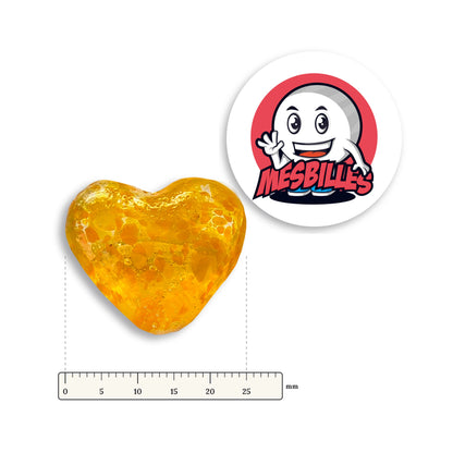 Bille Coeur Ambre Mouchetée Orange à côté d'une règle graduée, environ 25 mm de large