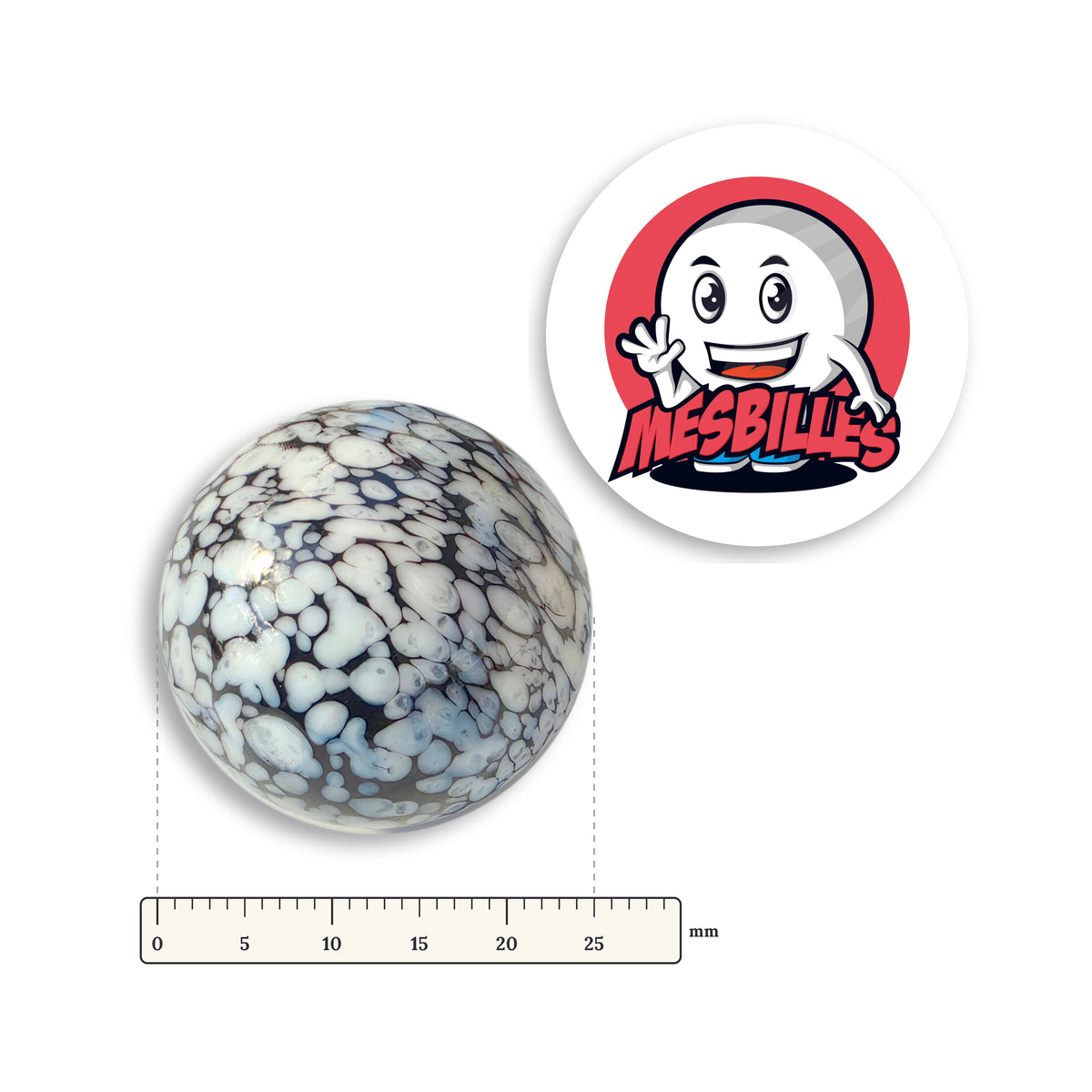 Bille Noir Mouchetée Blanc 25 mm à côté d'une règle graduée, 25 mm de diamètre